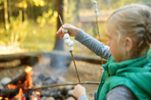 young girl making s'mores